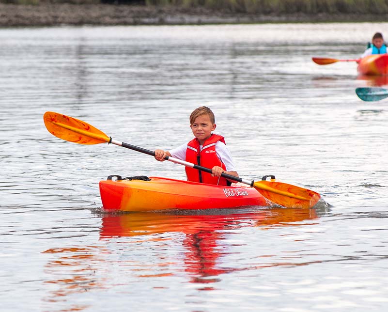 Boy paddling in the Old Town Heron JR kayak