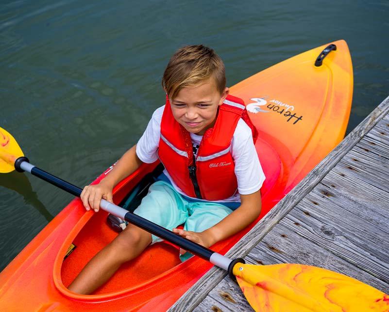 Young boy in the Old Town Heron Junior kayak