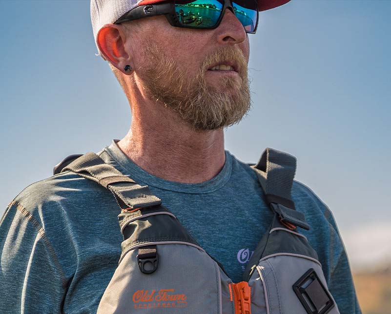 Man wearing Old Town Treble Angler Sportsman life jacket