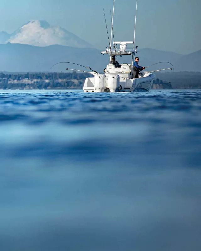 Anglers fishing with downriggers on a boat in the pacific northwest